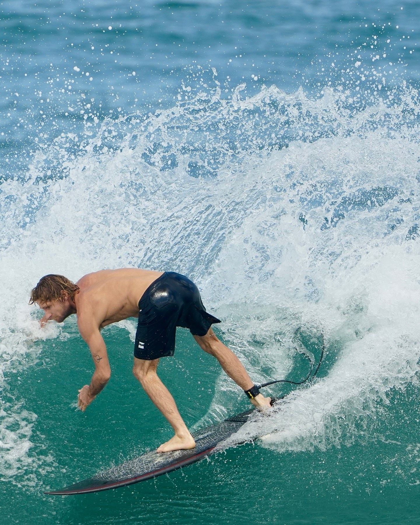 Surfer carving at Echo Beach