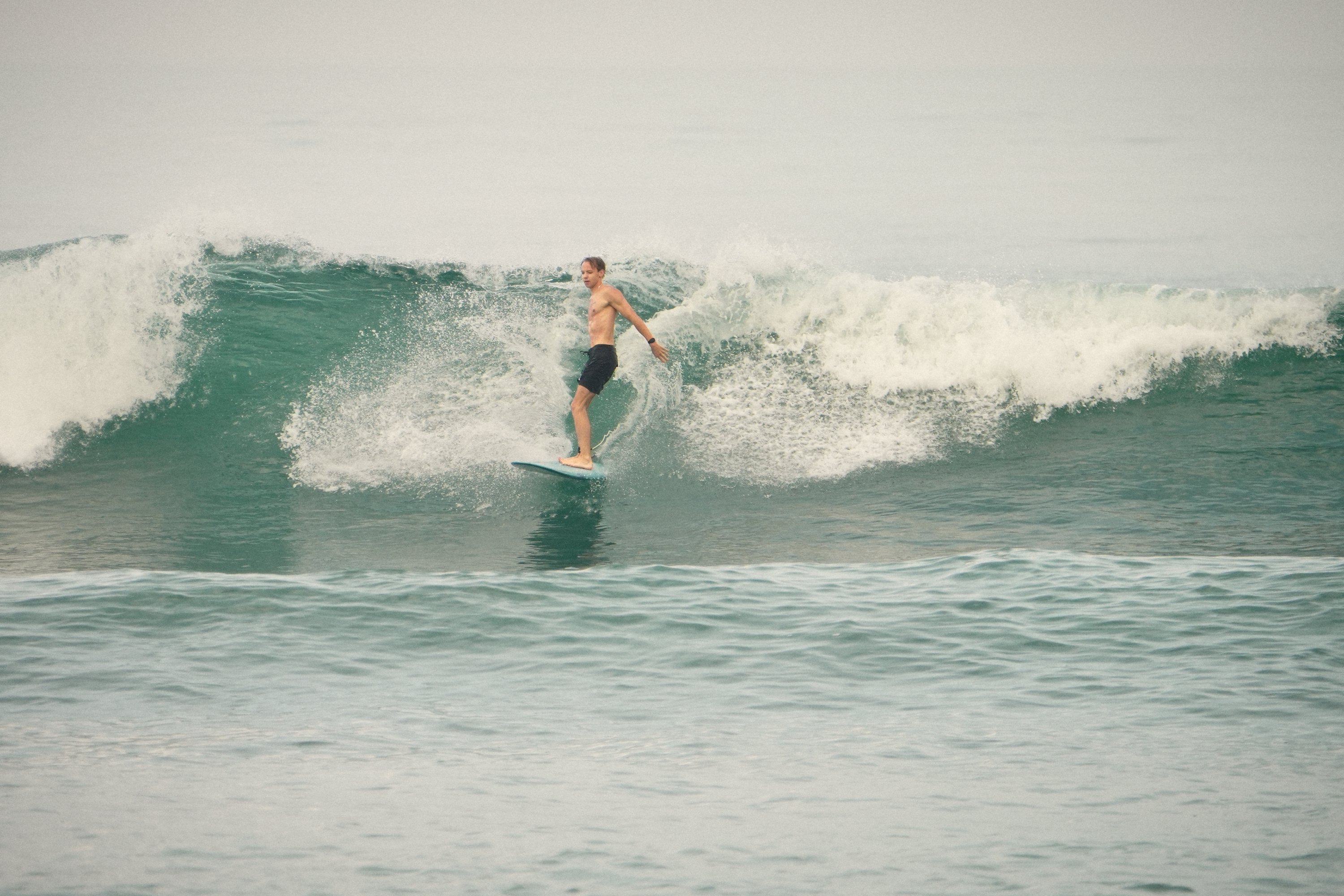 A big green wave at Batu Bolong with a surfer on the face